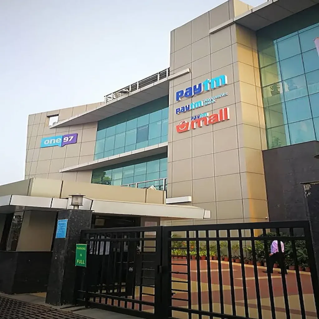 One97 Communications and Paytm headquarters building in Noida featuring Paytm Payments Bank and Paytm Mall signage